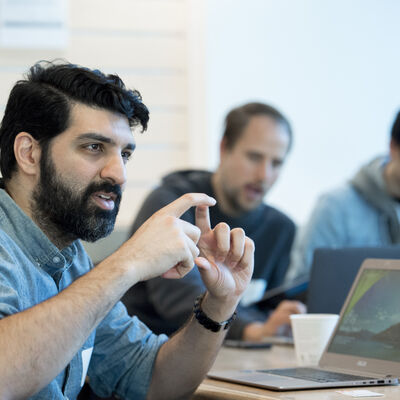 Man at computer speaking in a group