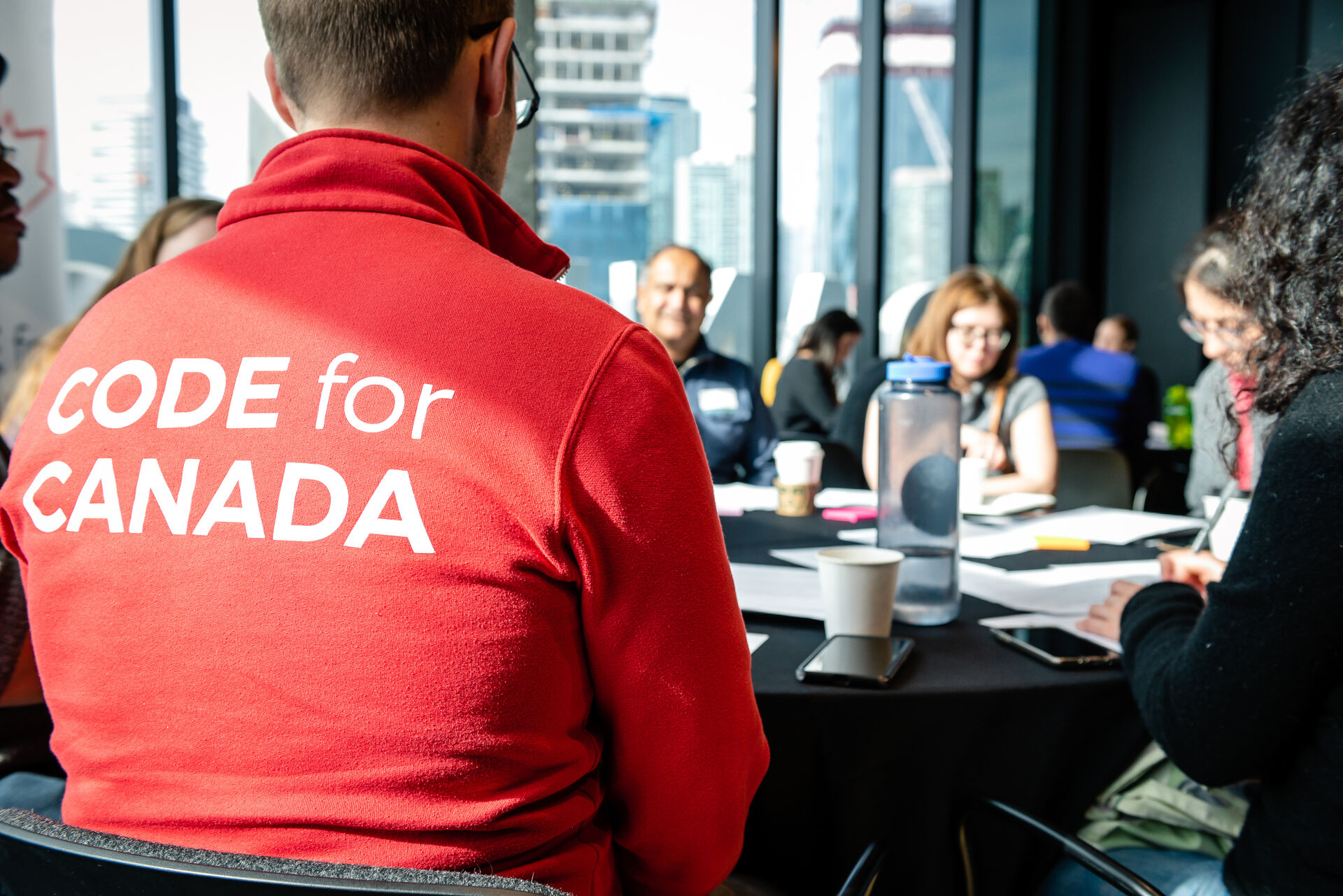 Group sitting at table c4c jacket